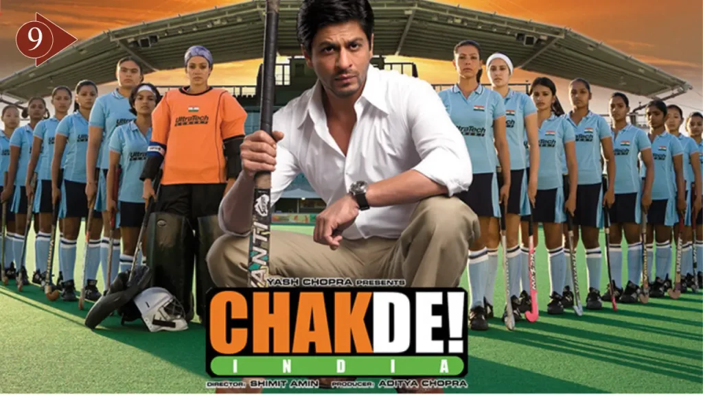Shah Rukh Khan as hockey coach Kabir Khan with the Indian women's hockey team in the Chak De! India (2007) movie poster.