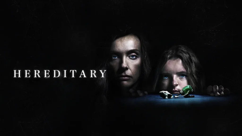 Dark psychological horror poster for Hereditary (2018), featuring a mother and daughter staring forward from the shadows beside a small broken green object.